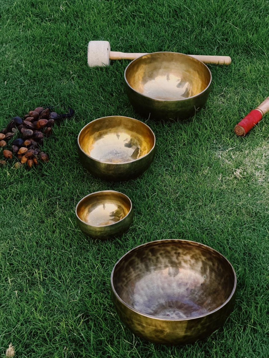 Singing bowls and beads on grass